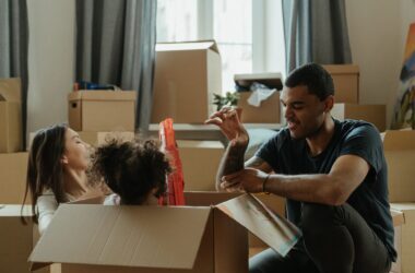 service-1 Family having fun unpacking boxes on moving day. A joyful moment of relocation.